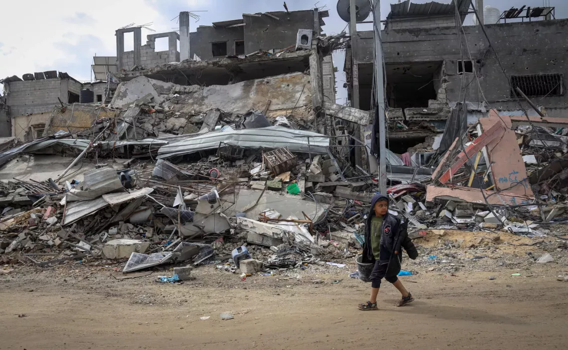 Gaza Strip. A boy walks past the rubble of a destroyed neighborhood in Khan Younis, southern the Gaza Strip.
